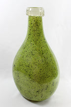 Green speckled bottle on a white background