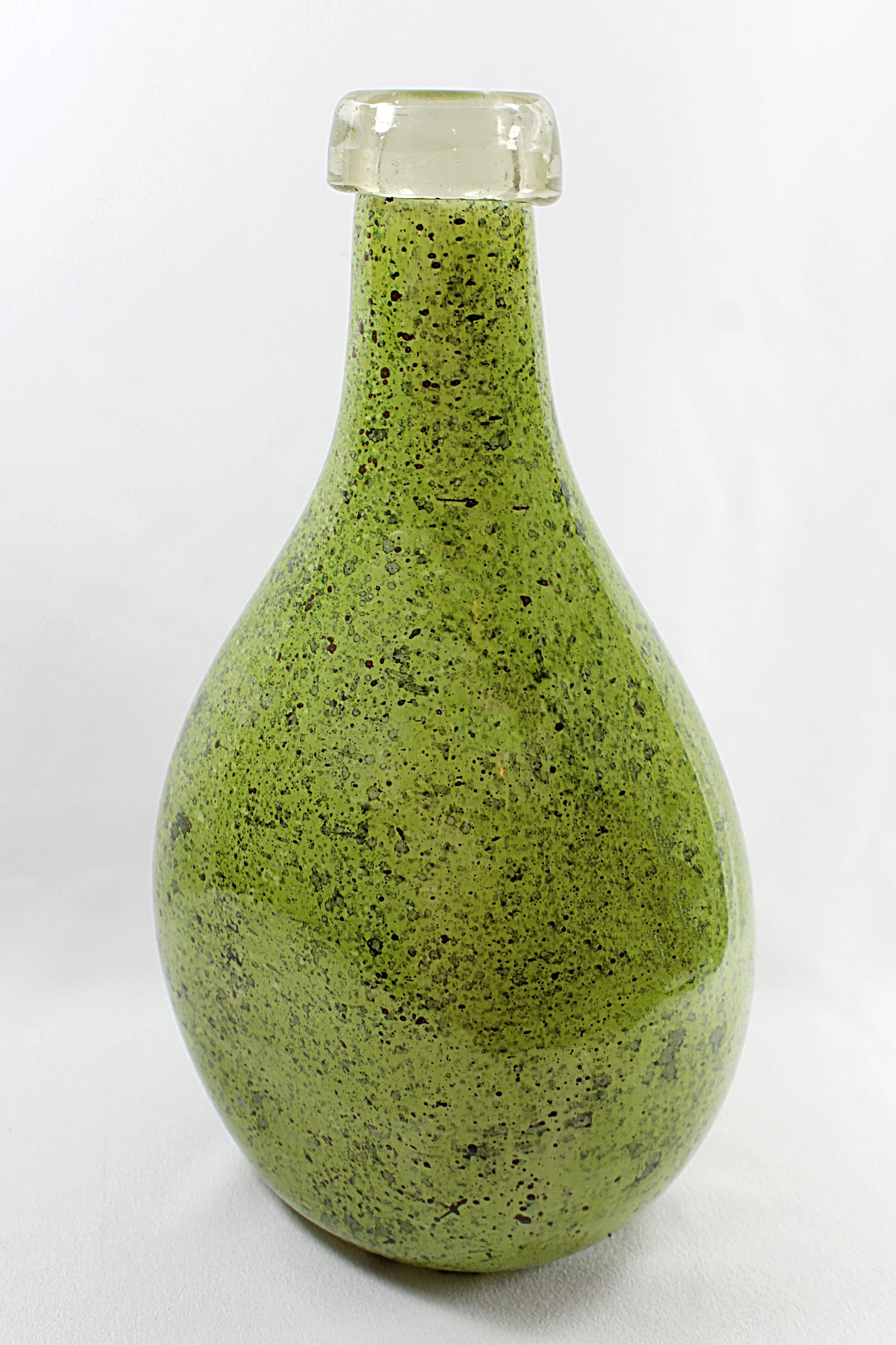 Green speckled bottle on a white background