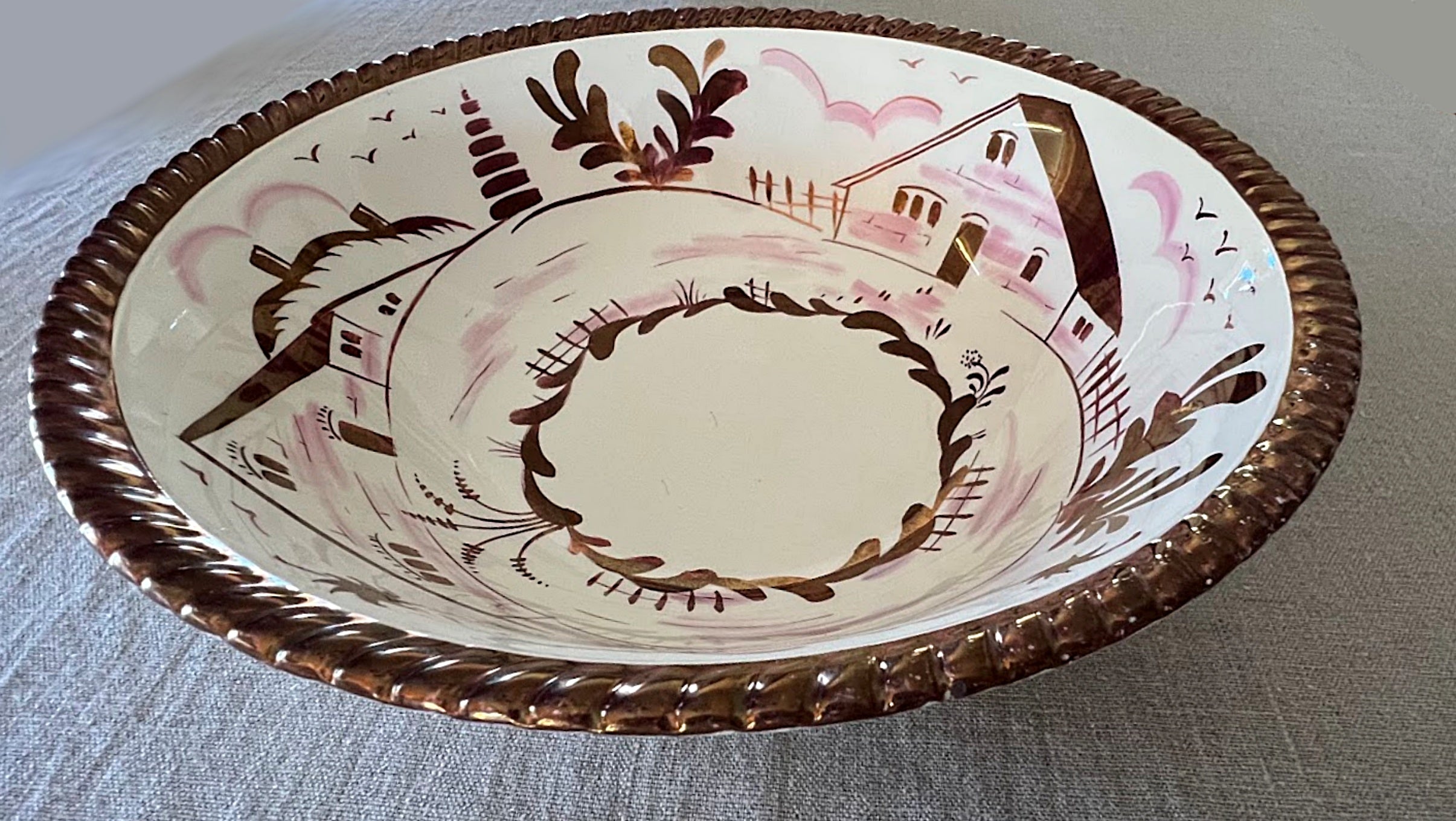 English Copper Luster Bowl by Gray's Pottery sitting on table runner