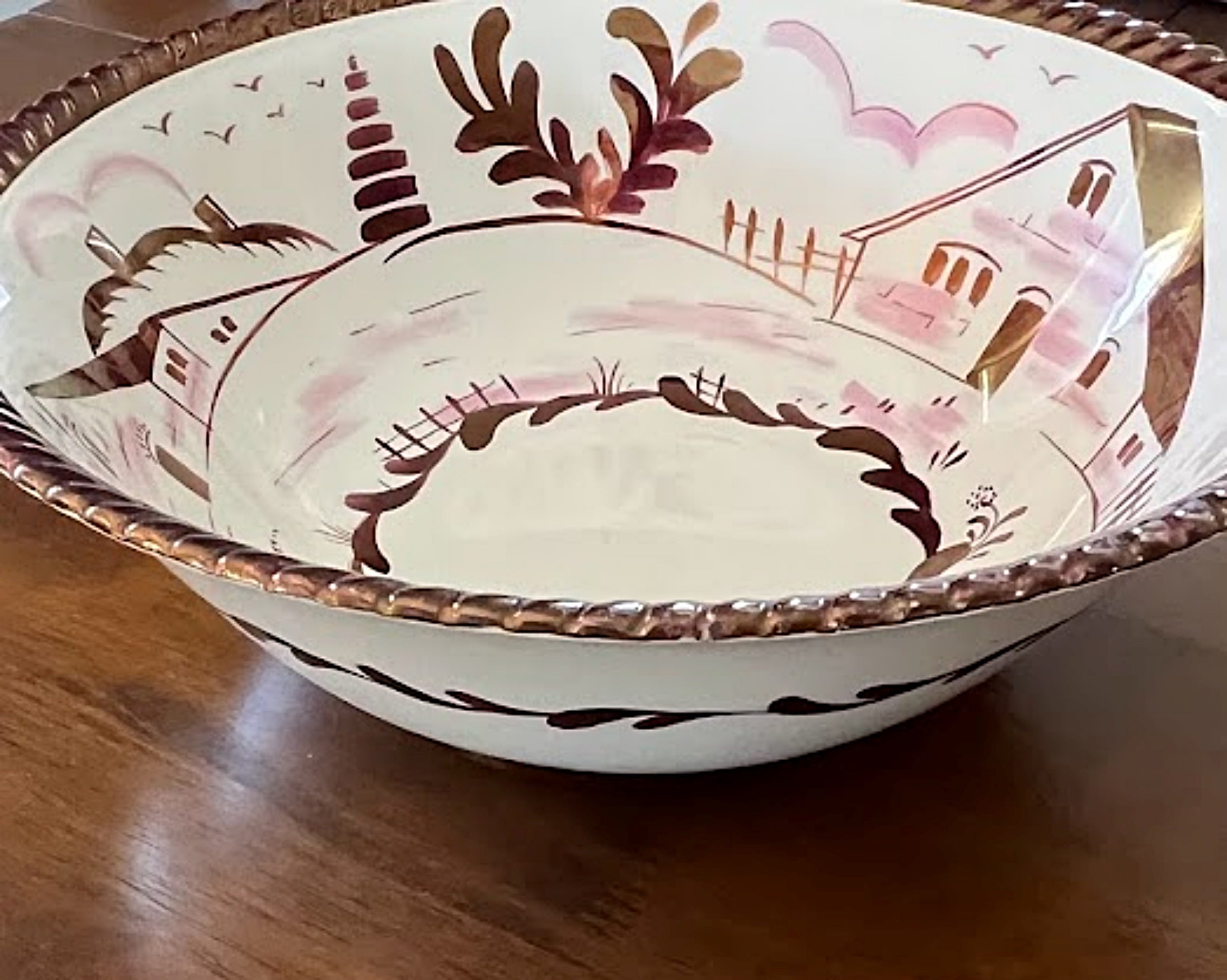 Decorative ceramic bowl with artistic design on a wooden surface
