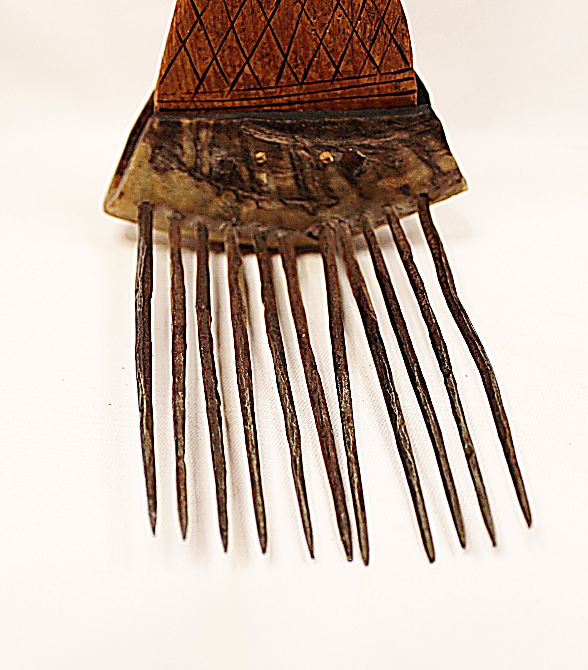 Vintage metal comb with wooden handle on a white background spikes closeup