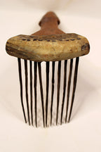 Vintage wooden comb with metal teeth on a white background