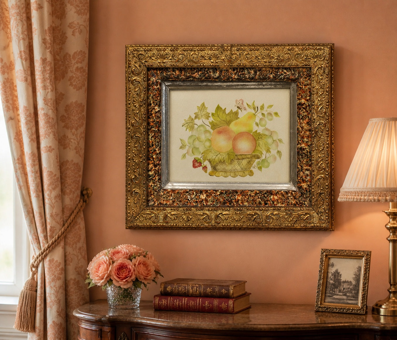Decorative painting in an ornate gold frame on a wall with a lamp and books on a table.