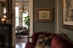 Antique Victorian Wood Frame Fruit Basket Theorem on Velvet on green wall in room with couch and fireplace