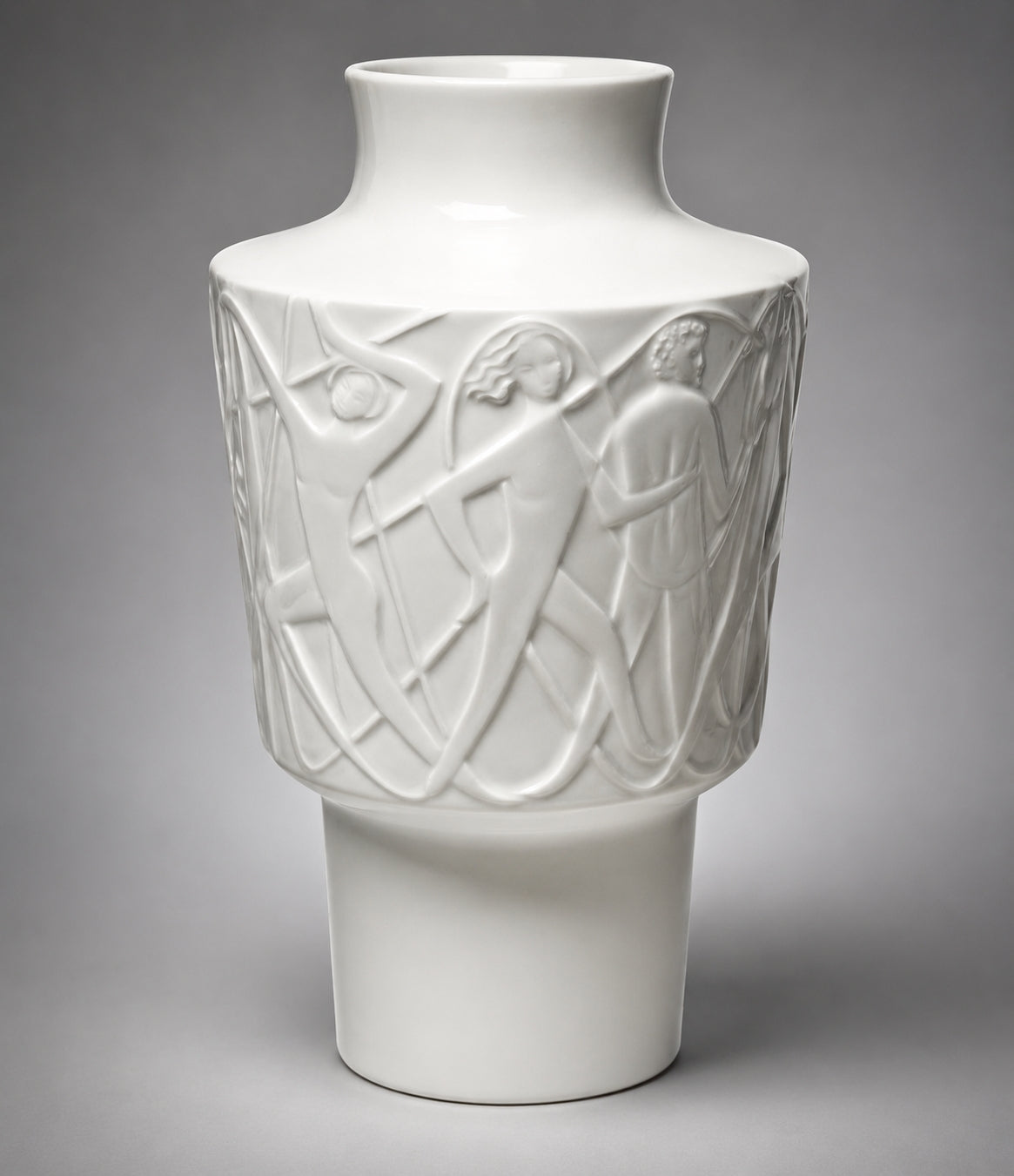 White ceramic vase with intricate carvings on a gray background