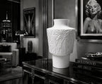 Decorative white vase on a table with Hollywood-themed decor in the background Marylin Monroe Picture
