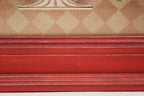 Close-up of a red wooden frame with a checkered pattern in the background