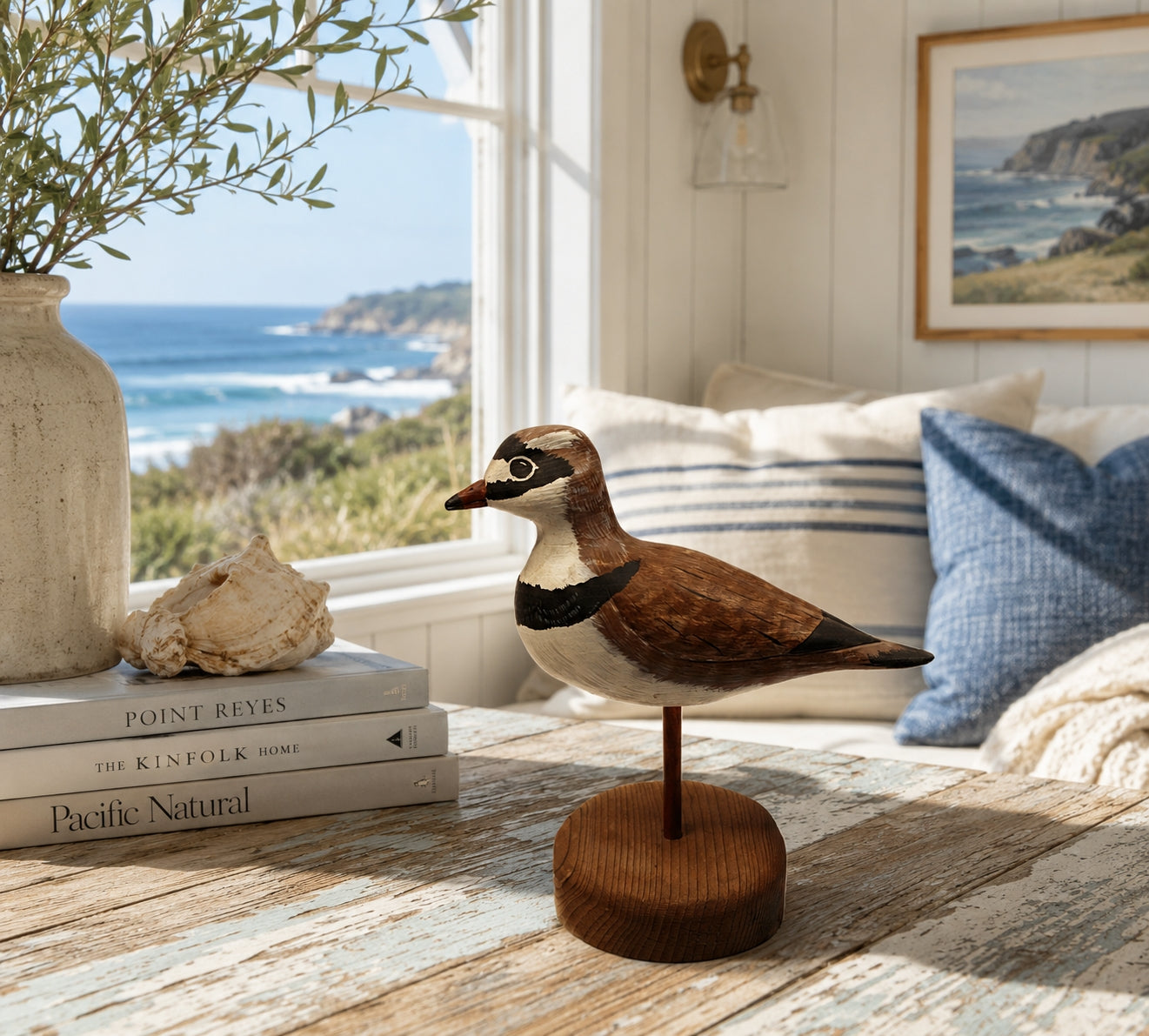 Shorebird Decoy Semipalmated Plover Gregg Ewell Carving 1981 Delaware In room by the Sea ith books, pillow and plant