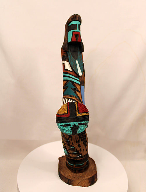 Decorative wooden sculpture with colorful abstract patterns on a white background
