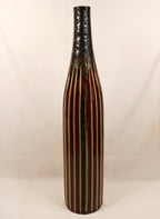 Tall ceramic vase with black and brown striped design on a white background