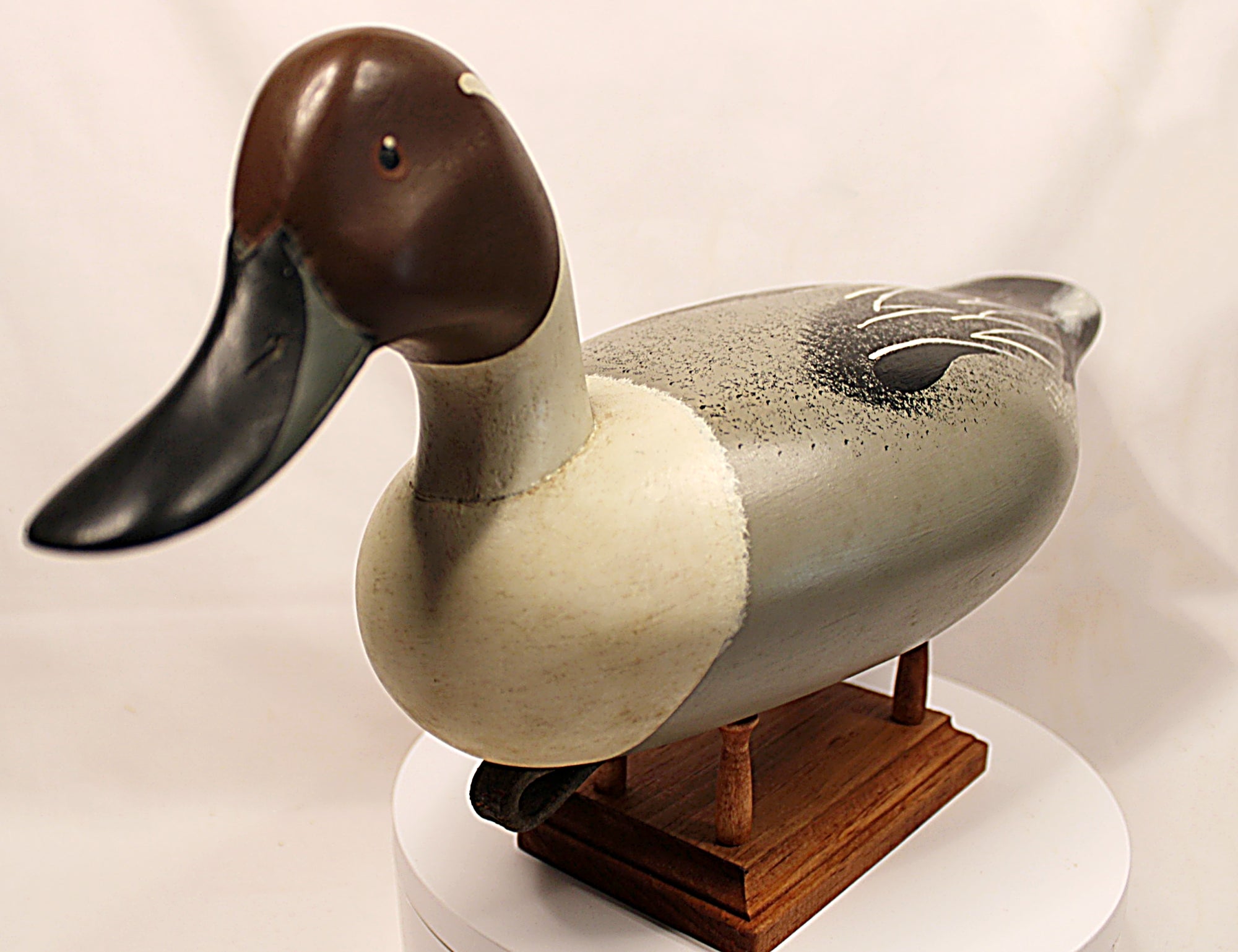 Duck decoy on a stand with a plain backgroundPintail Drake Duck Decoy Jim Burtis Maryland 1994