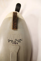 Close-up of a ceramic sculpture with 'JTB' and 'Jim Burtis, Riva MD 1994' marked on it
